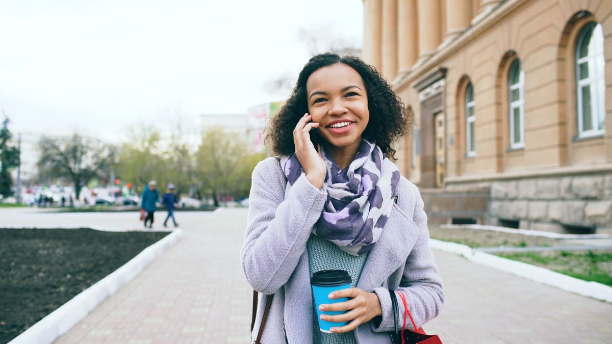 Customer checking a message on her phone outdoors